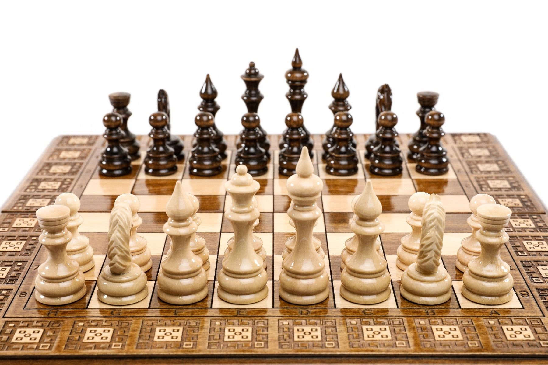 Dive into classic strategy with a unique, artisan-crafted chess set, where detailed carpet patterns provide a stunning visual backdrop.